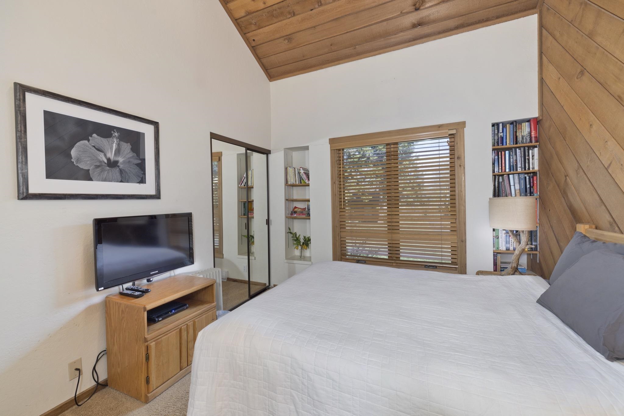 417 Snowcreek Road, Unit 417 Mammoth Lakes, CA 93546 - Photo 27 of 31 Vaulted wood-paneled ceiling accentuates this room featuring wood-finish wall paneling, a built-in b