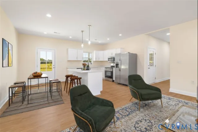 a living room with furniture and kitchen view