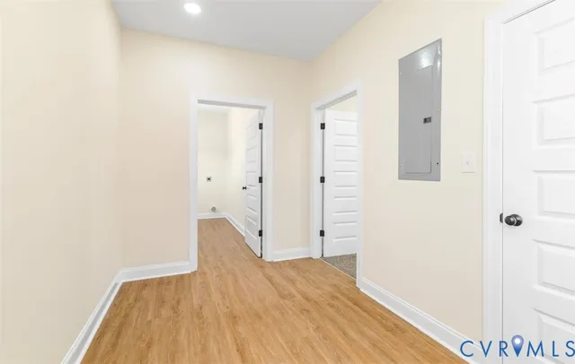 a view of a hallway with wooden floor and staircase