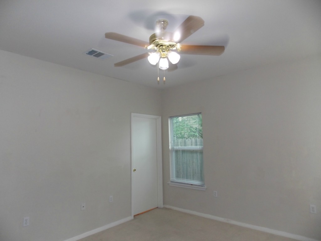 7315 Bethune Avenue, Unit A Austin, TX 78752 - Photo 5 of 8 an empty room with windows and fan