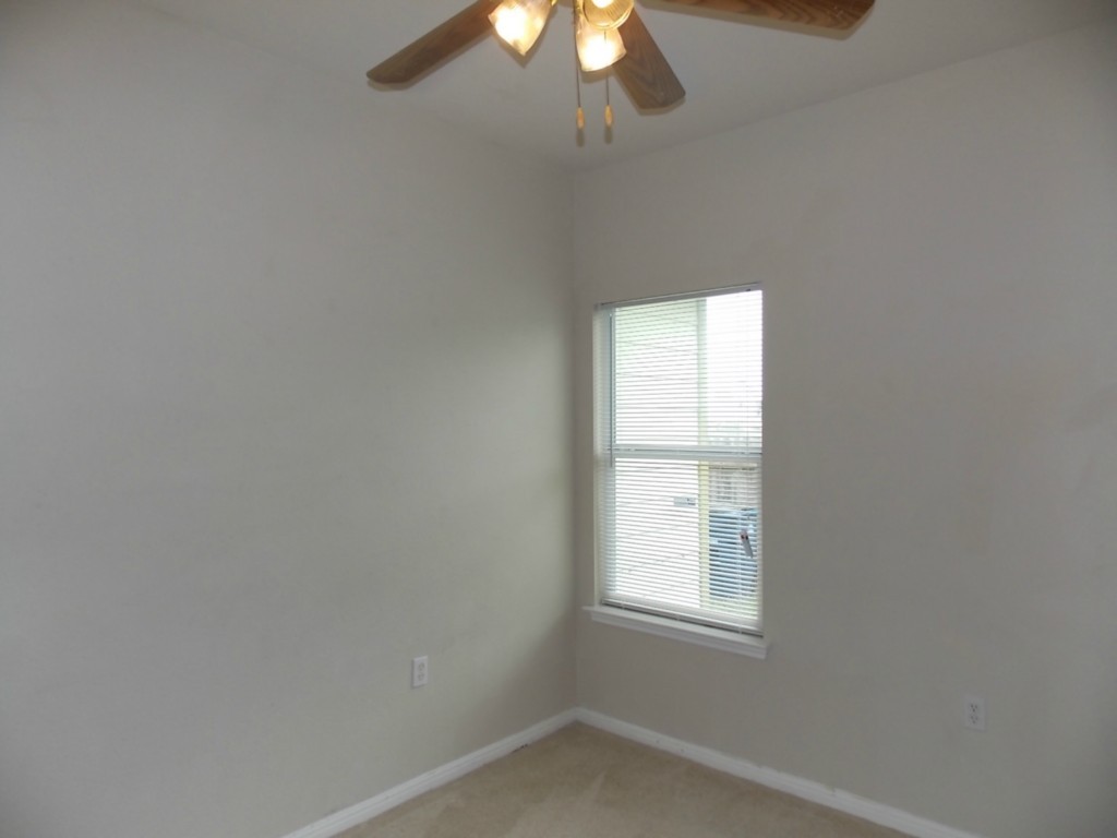 7315 Bethune Avenue, Unit A Austin, TX 78752 - Photo 7 of 8 an empty room with a window and a fan