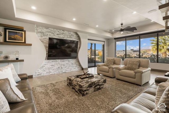 3652 South Cypress Road Hurricane, UT 84737 - Photo 27 of 81 Living space featuring large format tile flooring, a decorative stone accent wall, recessed lighting, and a ceiling fan
