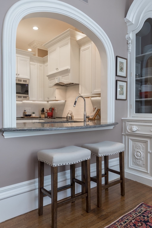 129 Beacon Street, Unit 1 Boston, MA 02116 - Photo 14 of 42 a kitchen with a table chairs sink and cabinets