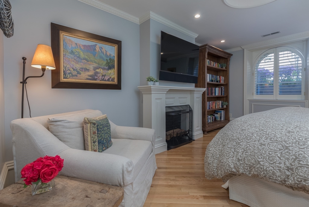129 Beacon Street, Unit 1 Boston, MA 02116 - Photo 21 of 42 a living room with furniture a flat screen tv and a fireplace