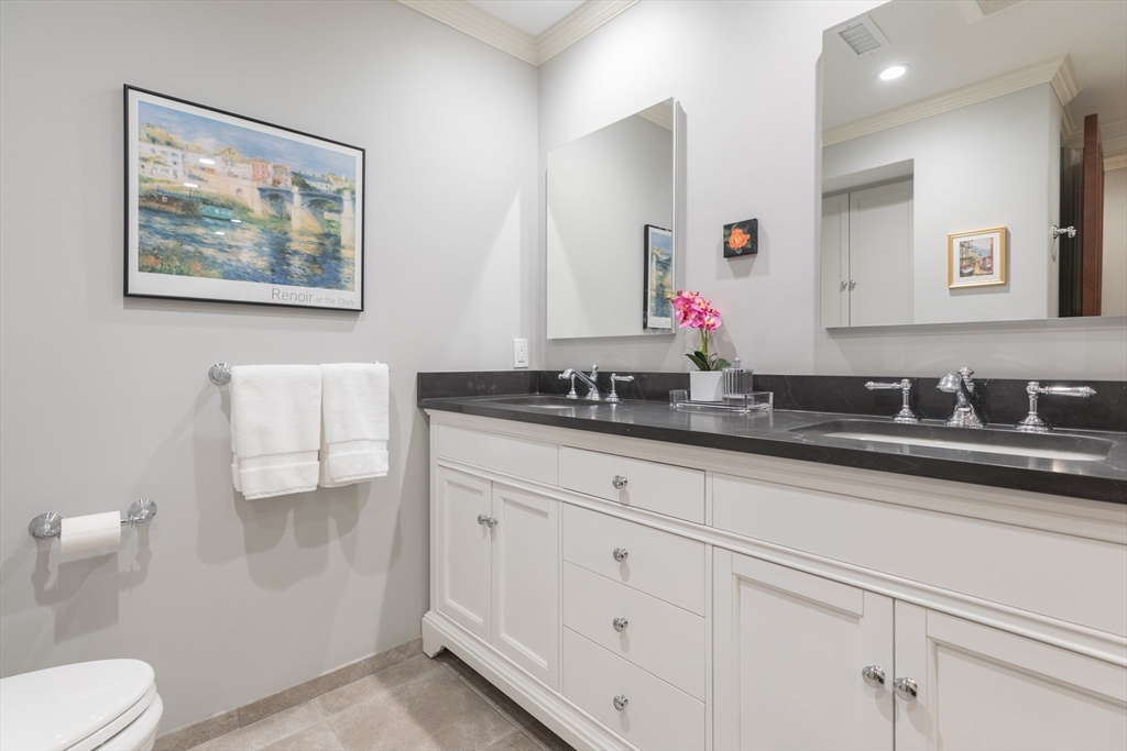 129 Beacon Street, Unit 1 Boston, MA 02116 - Photo 25 of 42 a bathroom with a double vanity sink and a mirror