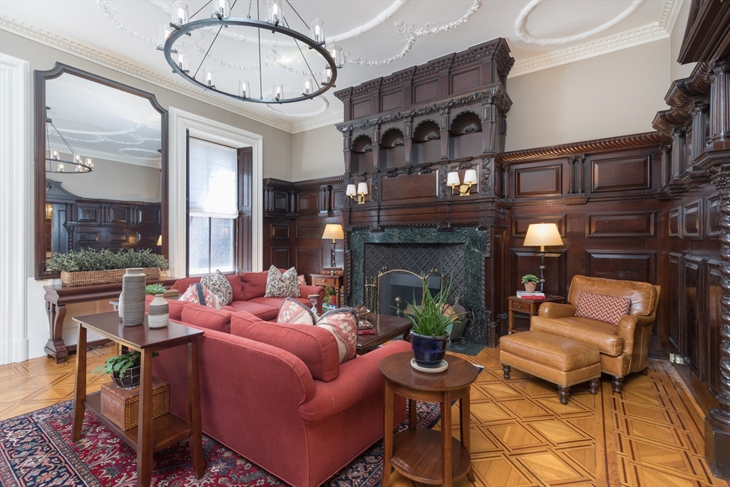 129 Beacon Street, Unit 1 Boston, MA 02116 - Photo 3 of 42 a living room with furniture a fireplace and a floor to ceiling window