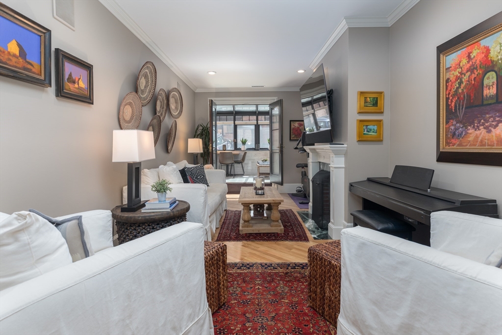 129 Beacon Street, Unit 1 Boston, MA 02116 - Photo 31 of 42 a living room with furniture and a fireplace