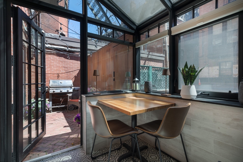 129 Beacon Street, Unit 1 Boston, MA 02116 - Photo 34 of 42 a patio with table and chairs and potted plants