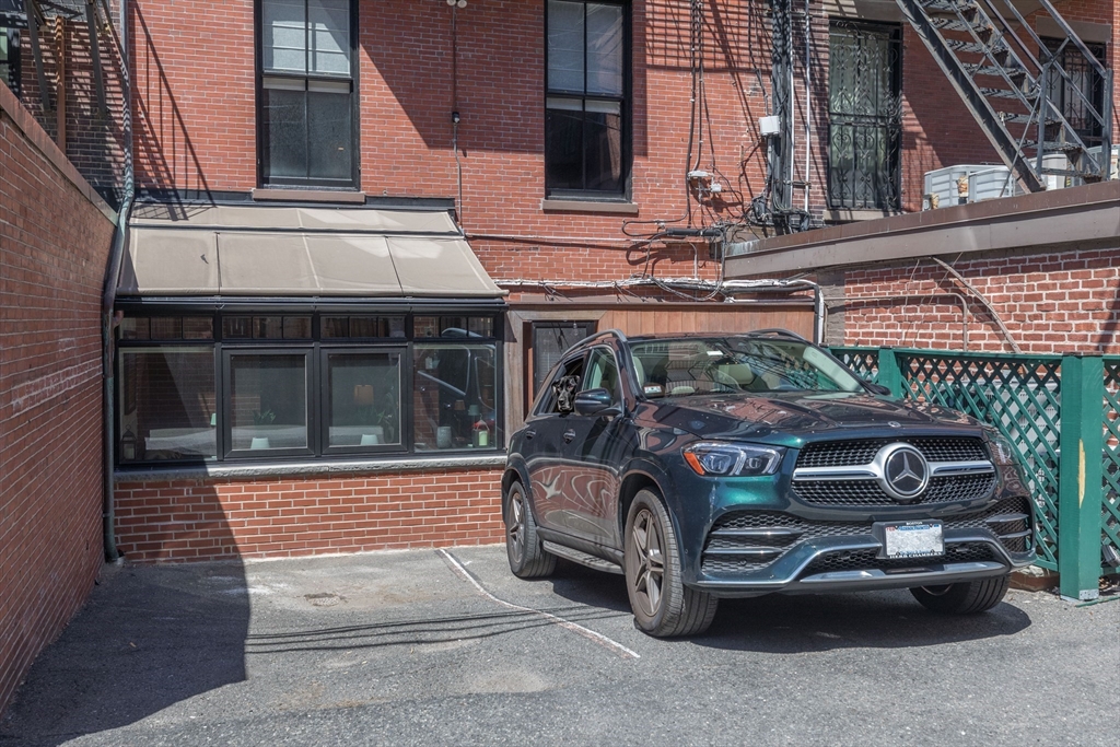 129 Beacon Street, Unit 1 Boston, MA 02116 - Photo 38 of 42 a car parked in front of a building