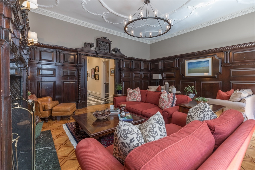 129 Beacon Street, Unit 1 Boston, MA 02116 - Photo 4 of 42 a living room with furniture a fireplace and chandelier