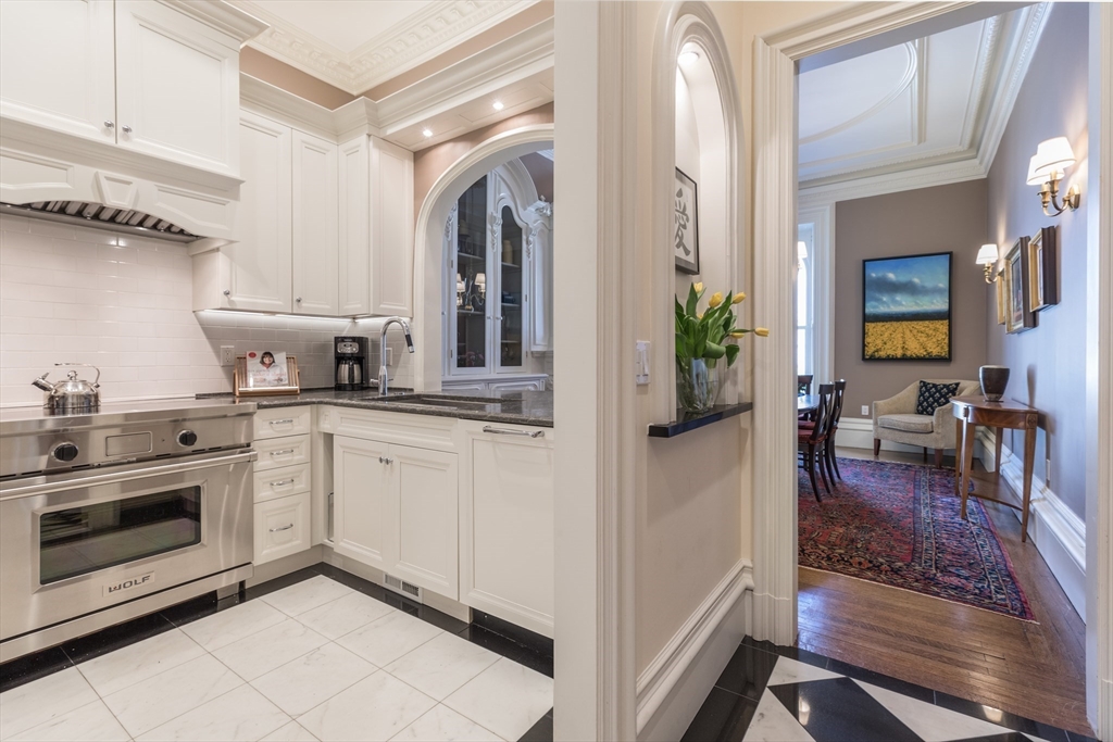 129 Beacon Street, Unit 1 Boston, MA 02116 - Photo 8 of 42 a kitchen with cabinets and wooden floor