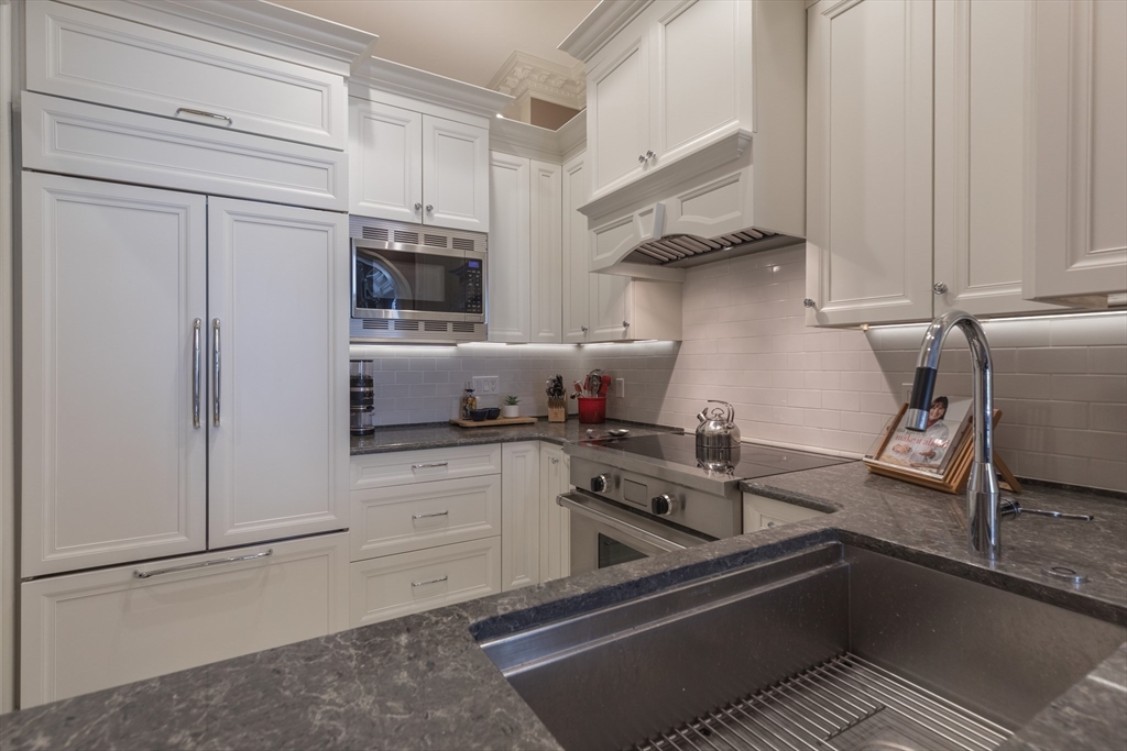 129 Beacon Street, Unit 1 Boston, MA 02116 - Photo 10 of 42 a kitchen with stainless steel appliances granite countertop a refrigerator and a stove