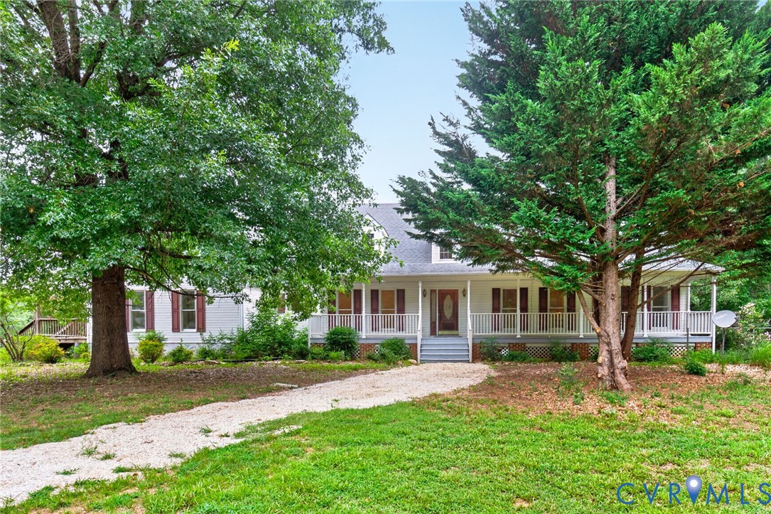 White siding exterior with a covered porch, dormer