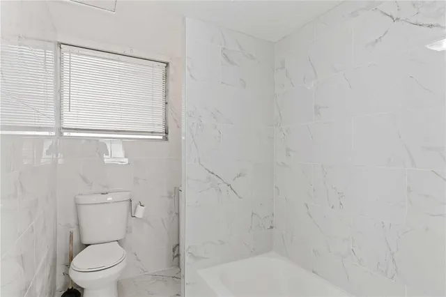 an aerial view of a houses with yard