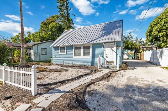 a view of a patio with table and chairs and potted plants