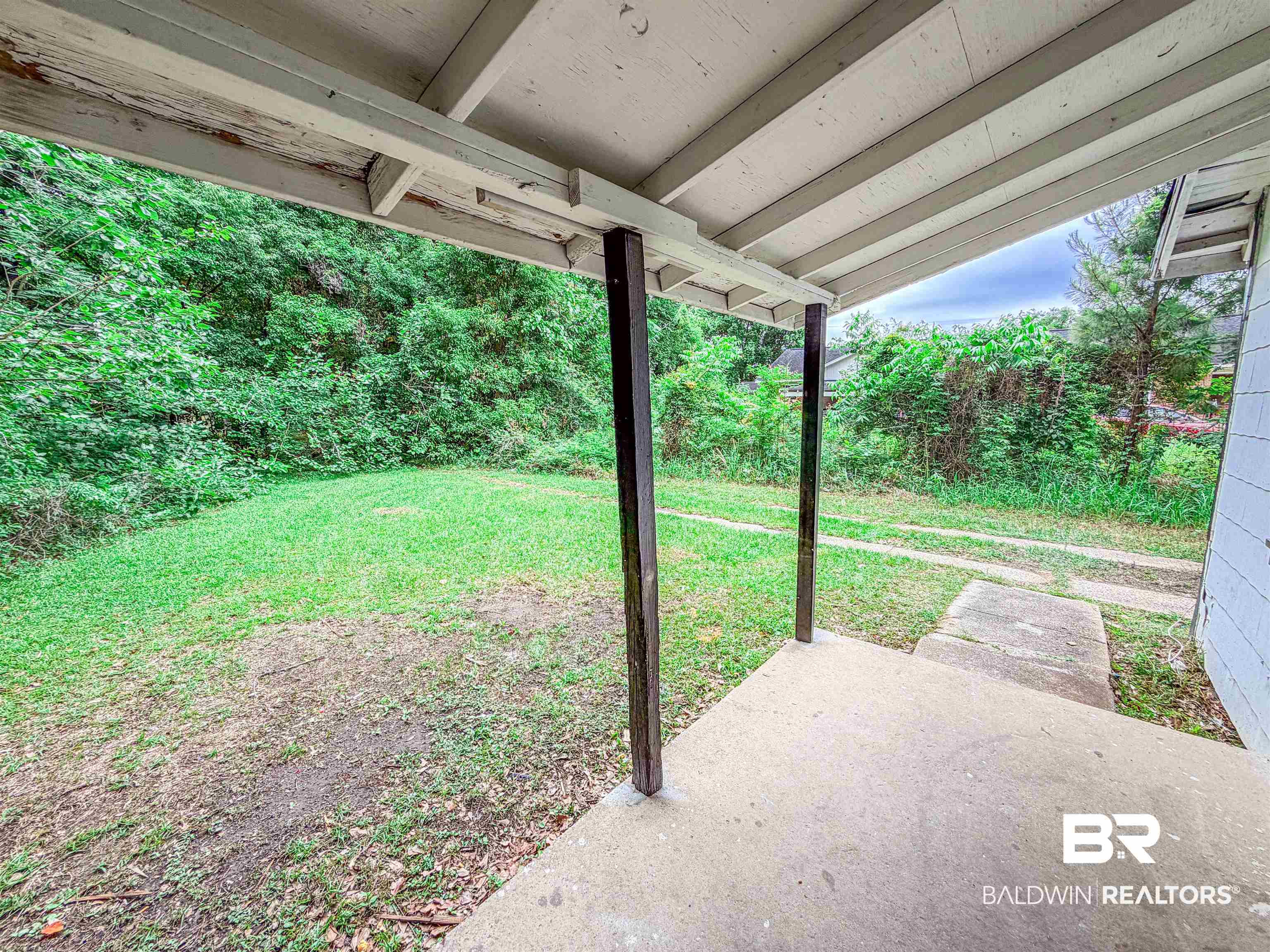 38 Flock Avenue Mobile, AL 36610 - Photo 25 of 27 Covered concrete porch with dark support columns