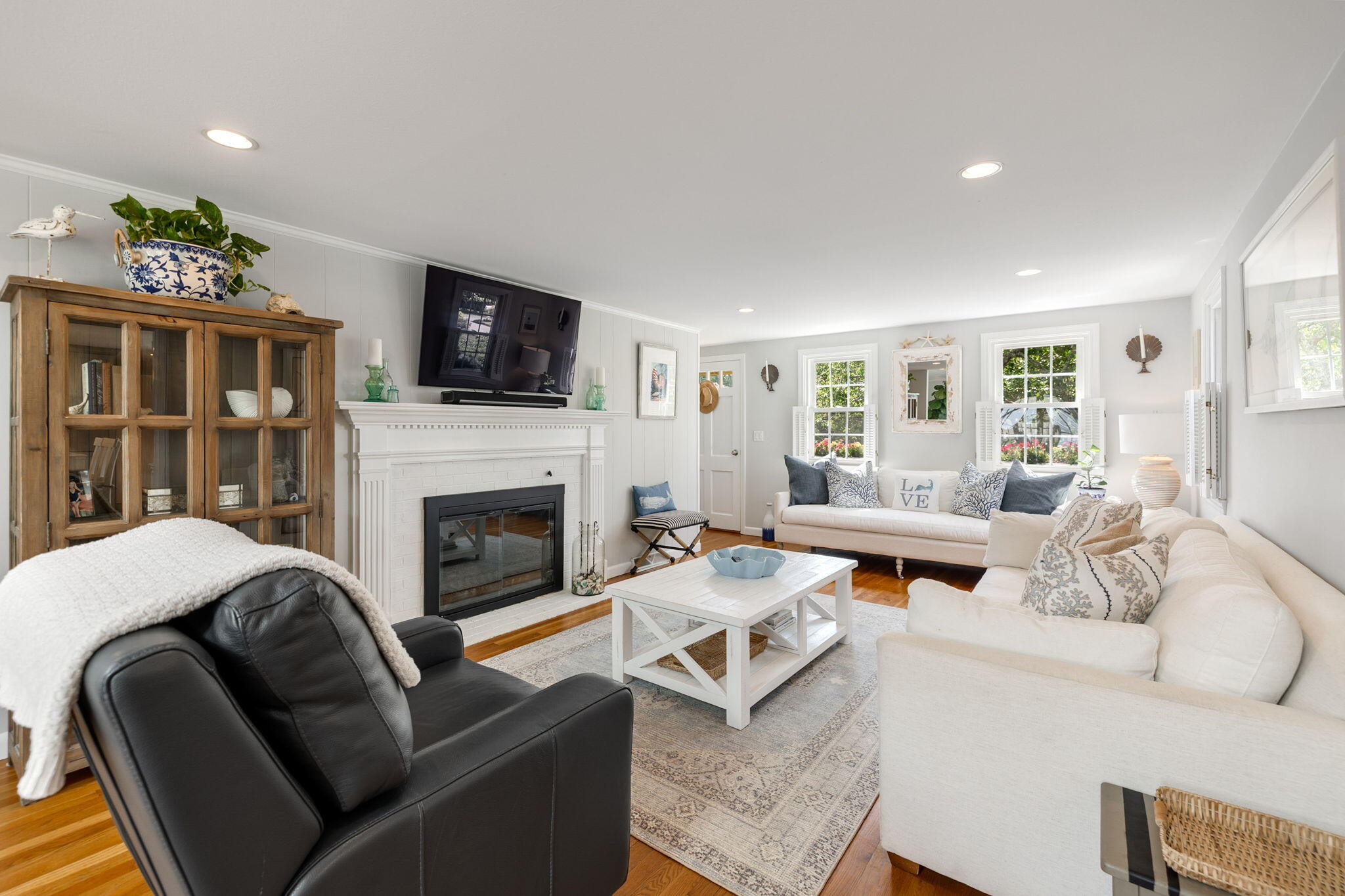 26 Captain Chase Road South Yarmouth, MA 02664 - Photo 12 of 54 a living room with furniture a flat screen tv and a fireplace