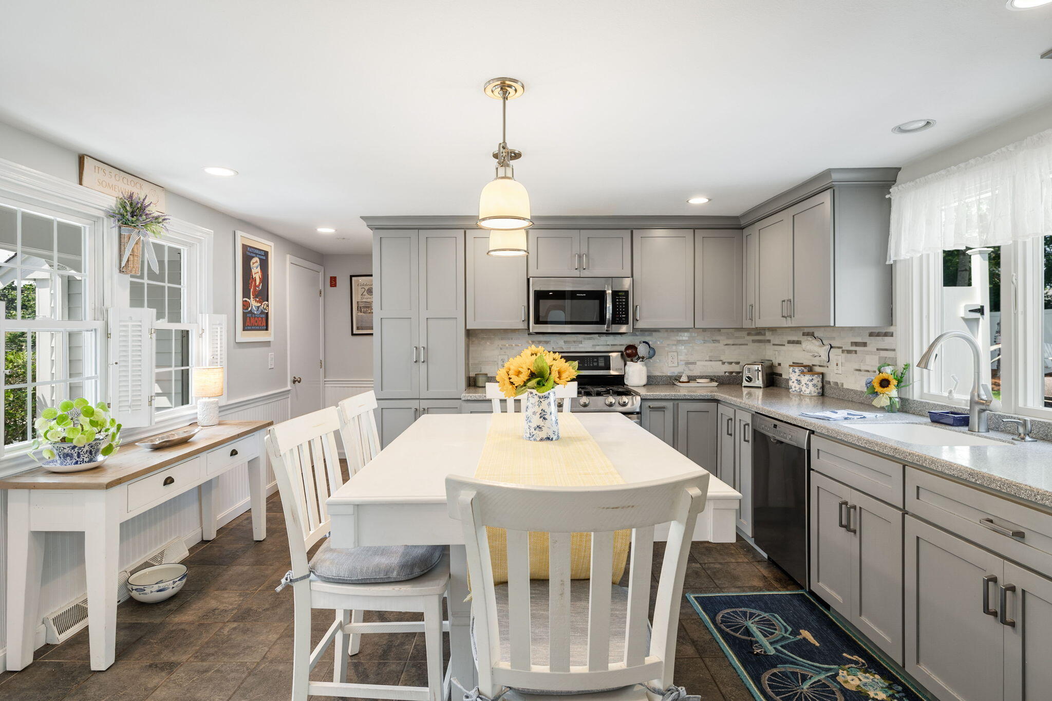 26 Captain Chase Road South Yarmouth, MA 02664 - Photo 9 of 54 a kitchen with microwave a stove a table and chairs