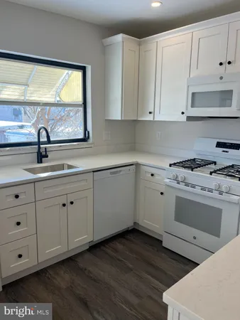 a kitchen with appliances cabinets and a window