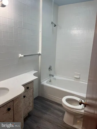 a bathroom with a sink a toilet and bathtub