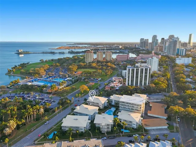an aerial view of residential building and lake