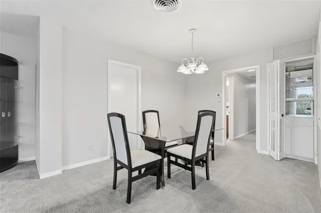 a dining room with furniture and chandelier