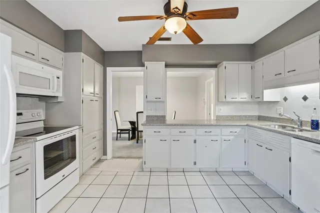 a bedroom with a bed and dresser with mirror