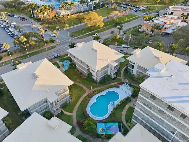 an aerial view of a house with outdoor space and a lake view