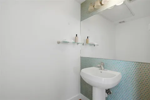 a bathroom with a sink a mirror and toilet