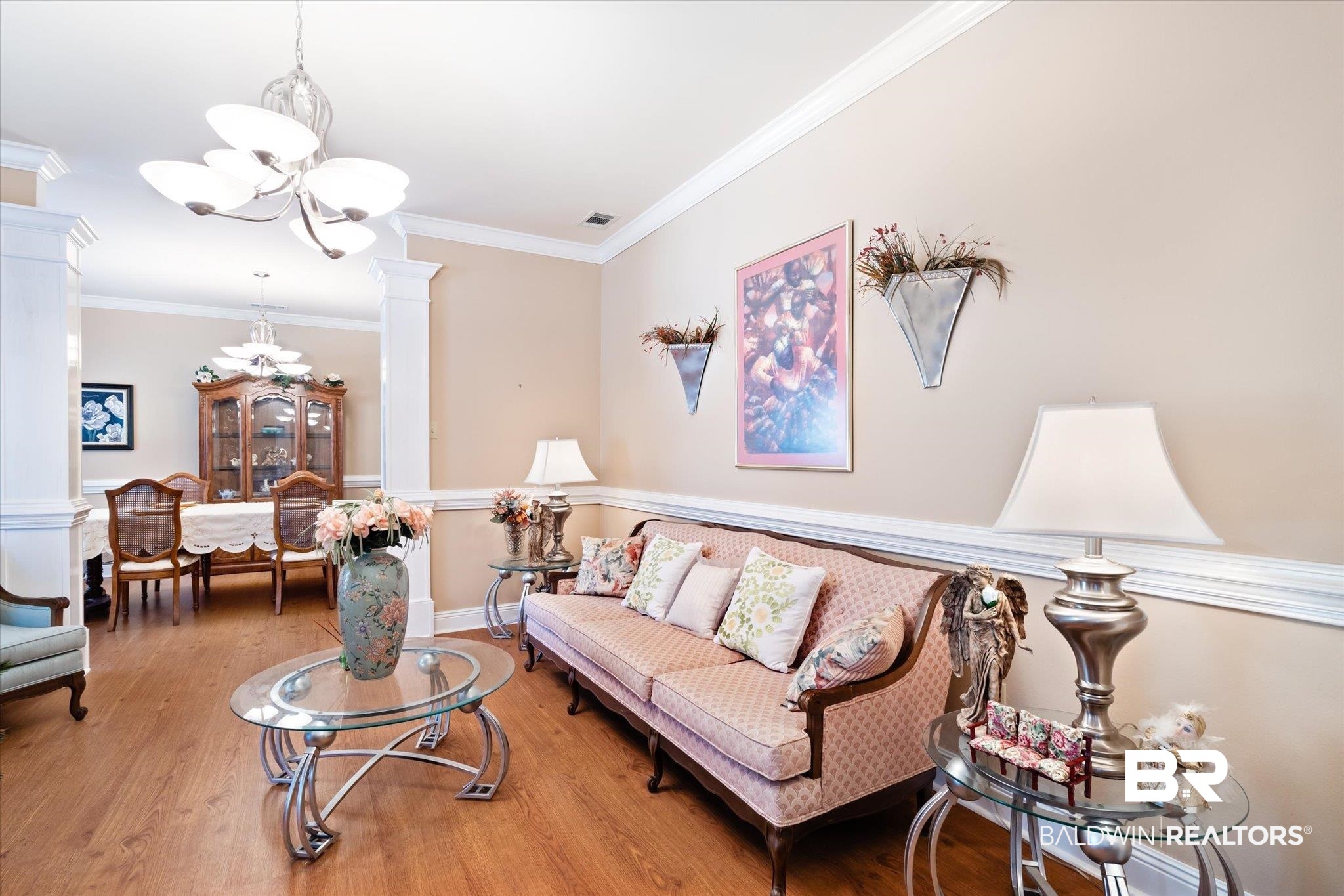 2400 Waterford Road Semmes, AL 36575 - Photo 3 of 30 Living room with a chandelier, decorative columns, light wood finished floors, and ornamental molding
