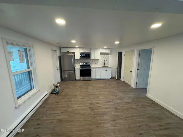 a view of gallery with wooden floor