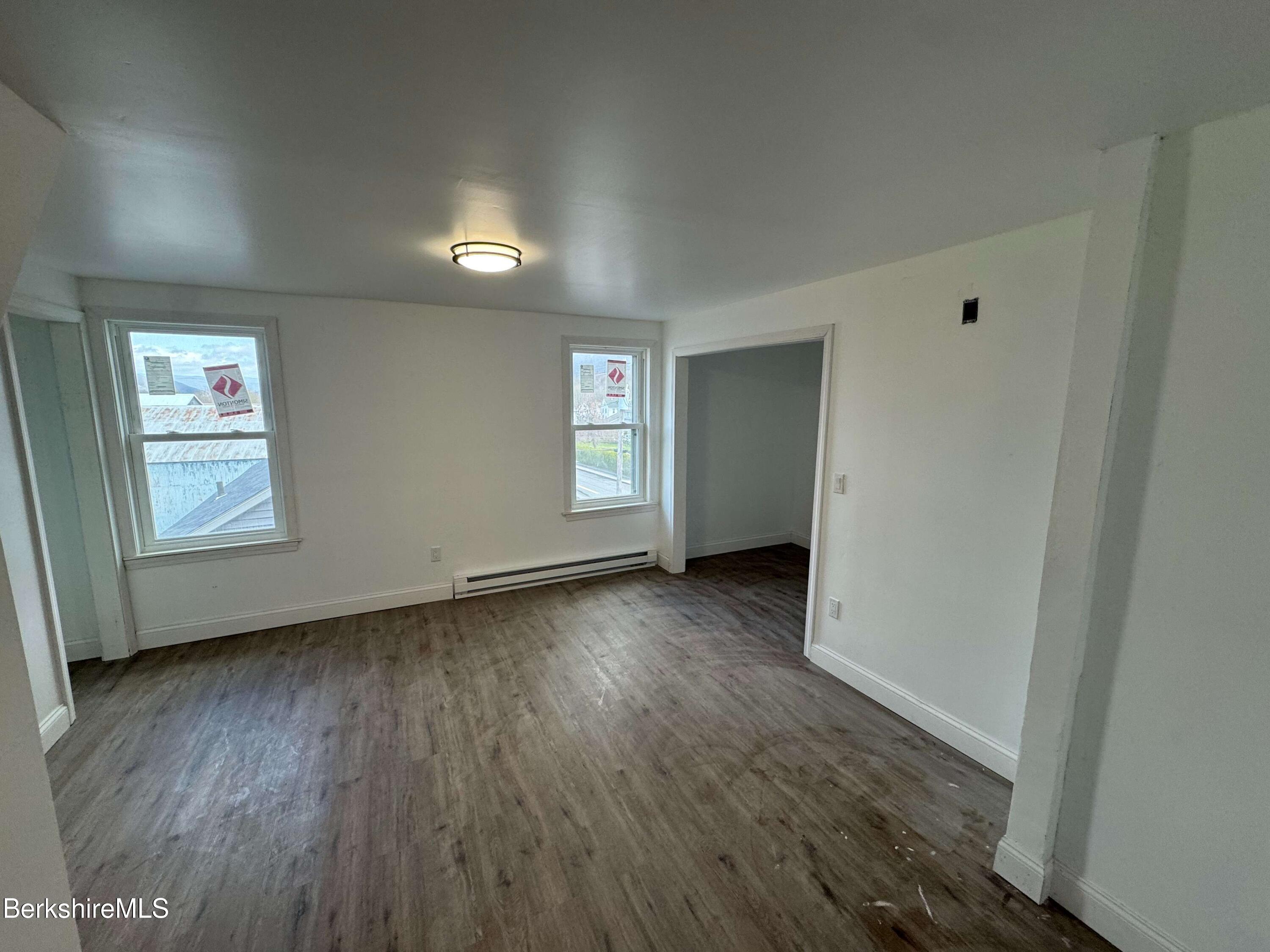 16 North Summer Street, Unit 6 Adams, MA 01220 - Photo 4 of 7 an empty room with wooden floor and windows
