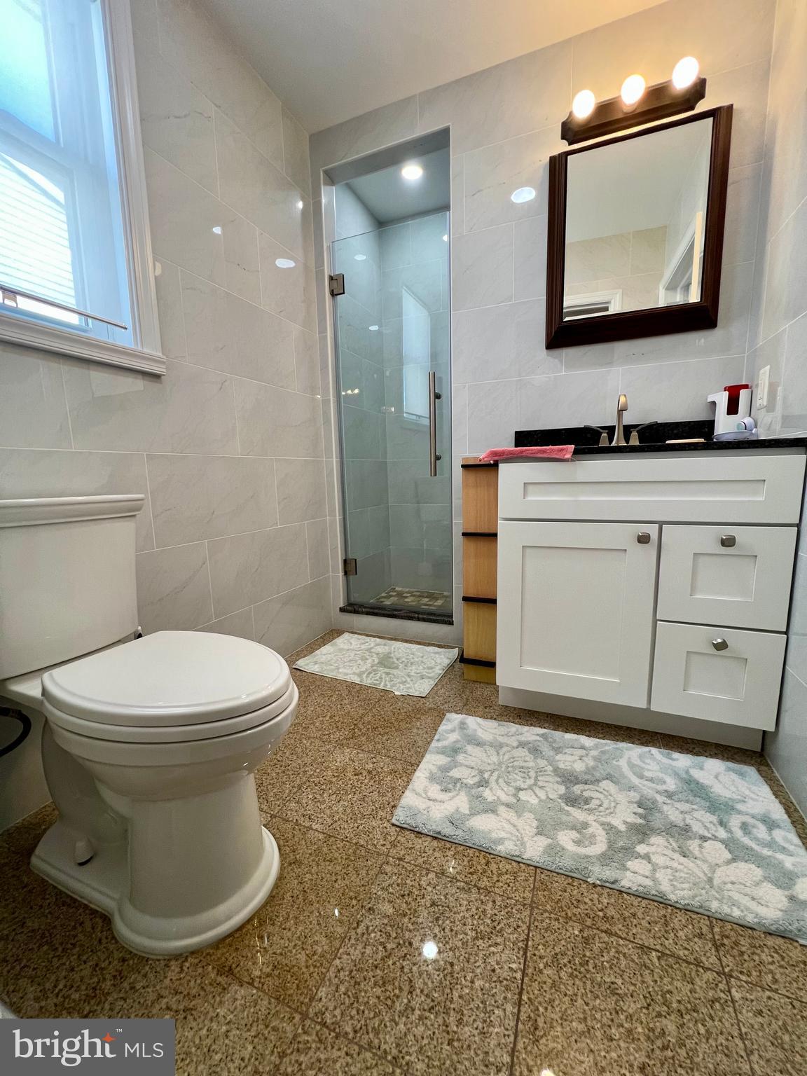 2988 Welsh Road Philadelphia, PA 19152 - Photo 23 of 38 a bathroom with a toilet sink and mirror