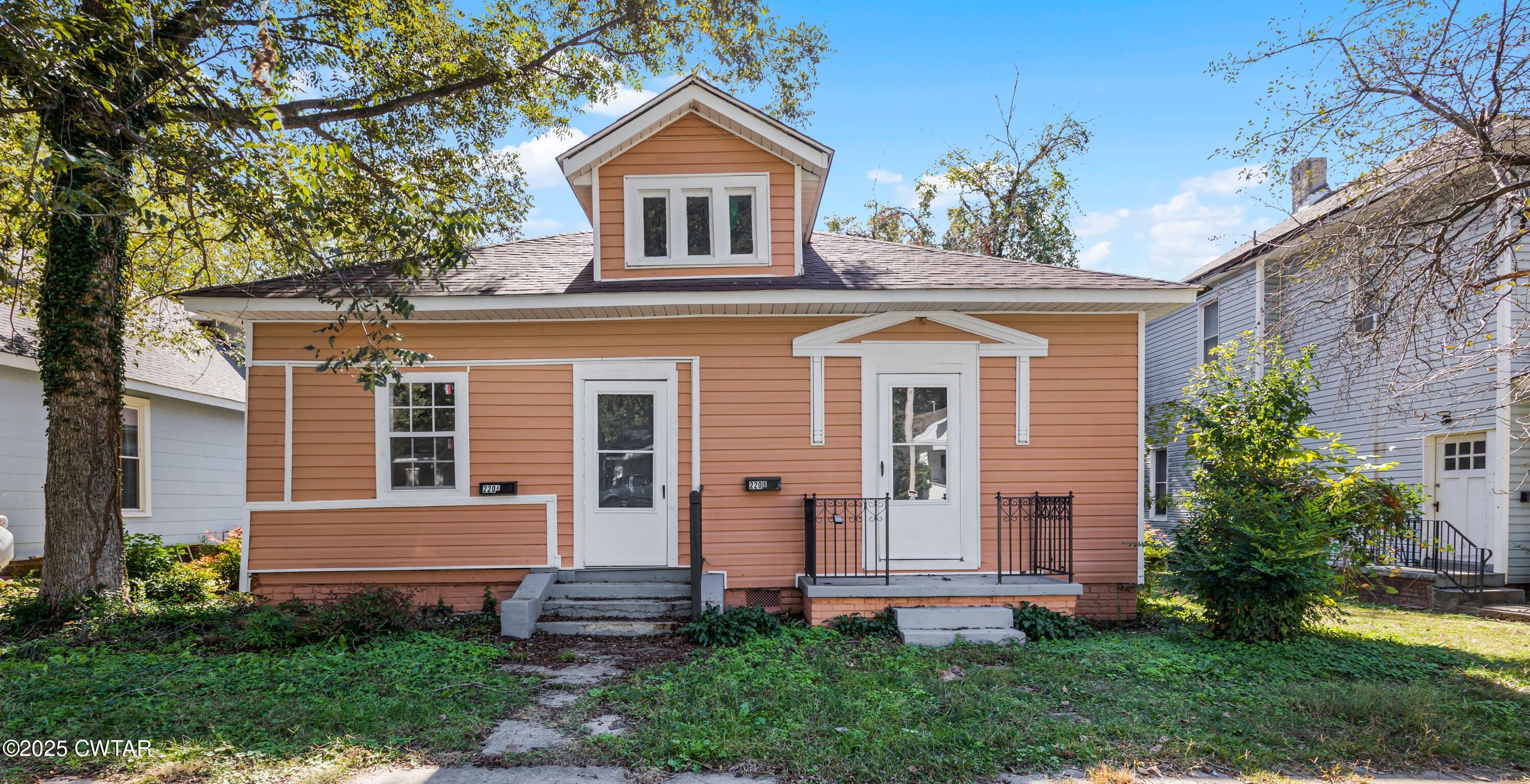 a front view of a house with garden