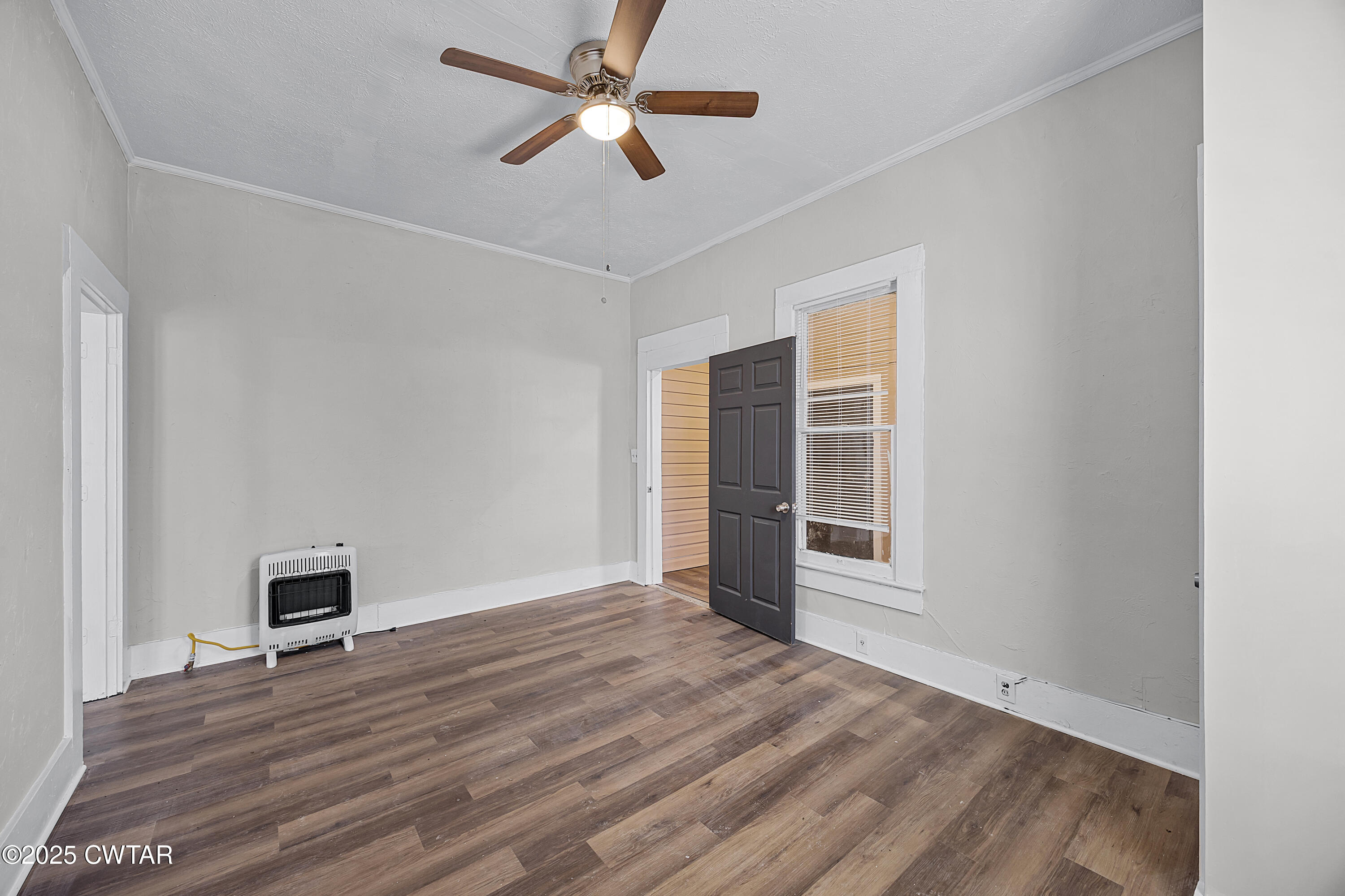 220 Division Avenue Jackson, TN 38301 - Photo 6 of 15 a view of empty room with wooden floor and fan