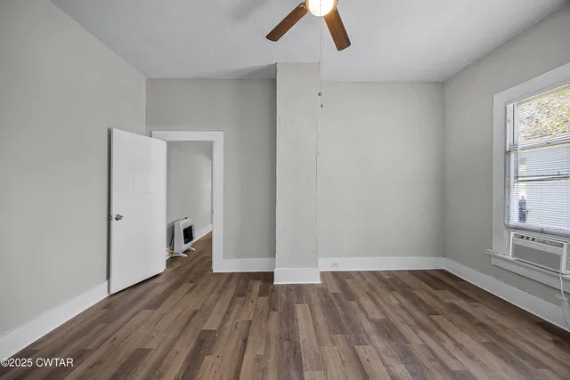 a view of an empty room and wooden floor