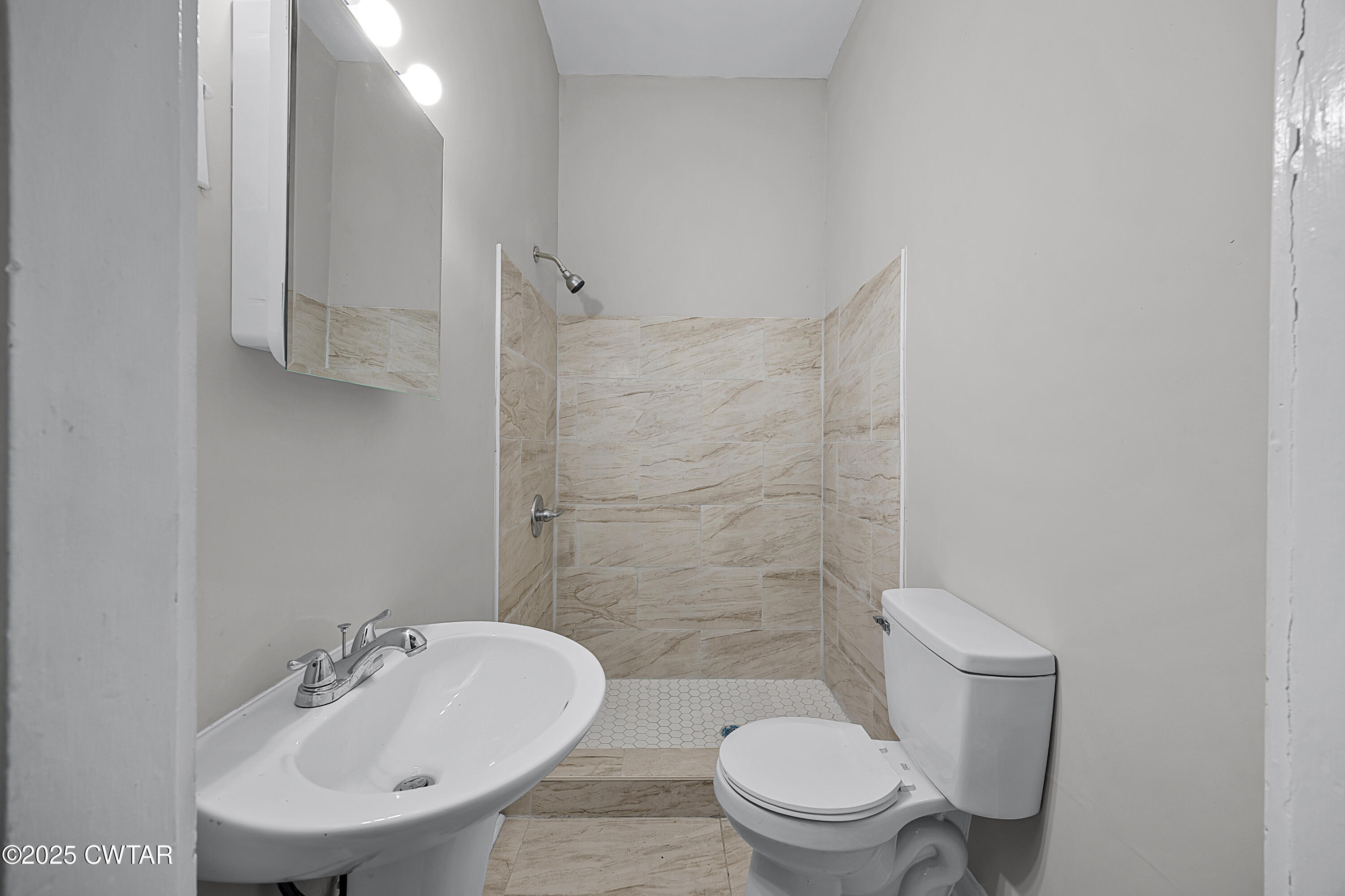 220 Division Avenue Jackson, TN 38301 - Photo 10 of 15 a bathroom with a sink a toilet and shower