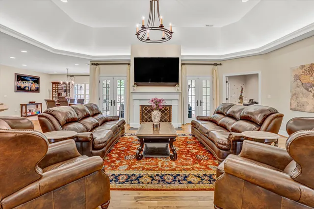 a kitchen with stainless steel appliances a dining table chairs and wooden floors