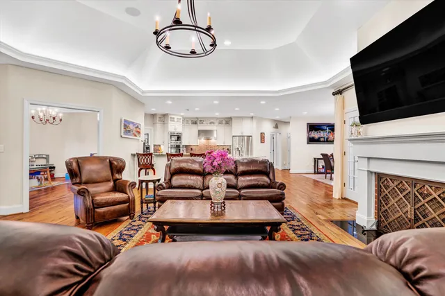 a large kitchen with stainless steel appliances kitchen island granite countertop a refrigerator and cabinets