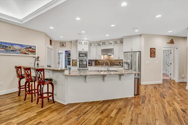 a living room with stainless steel appliances kitchen island granite countertop furniture and a kitchen view