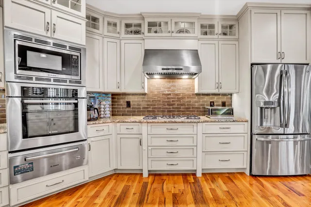 a bedroom with a large bed and painting on the wall