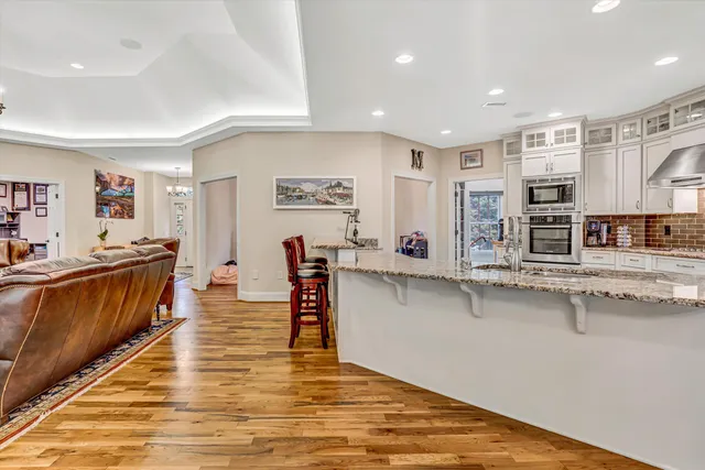 a white bath tub sitting in a bathroom next to a window