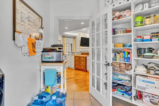 a view of walk in closet with clothes