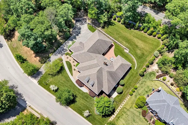 an aerial view of a house with outdoor space and a garden