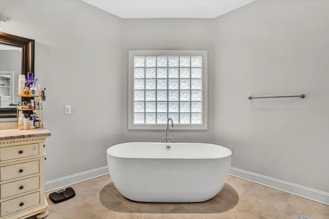 a bathroom with a sink double vanity granite tub shower and mirror