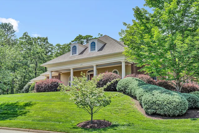 a front view of a house with a garden