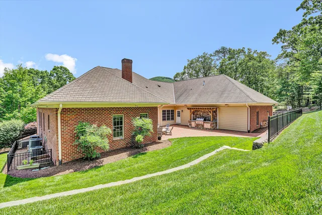 a living room with furniture a flat screen tv and a chandelier