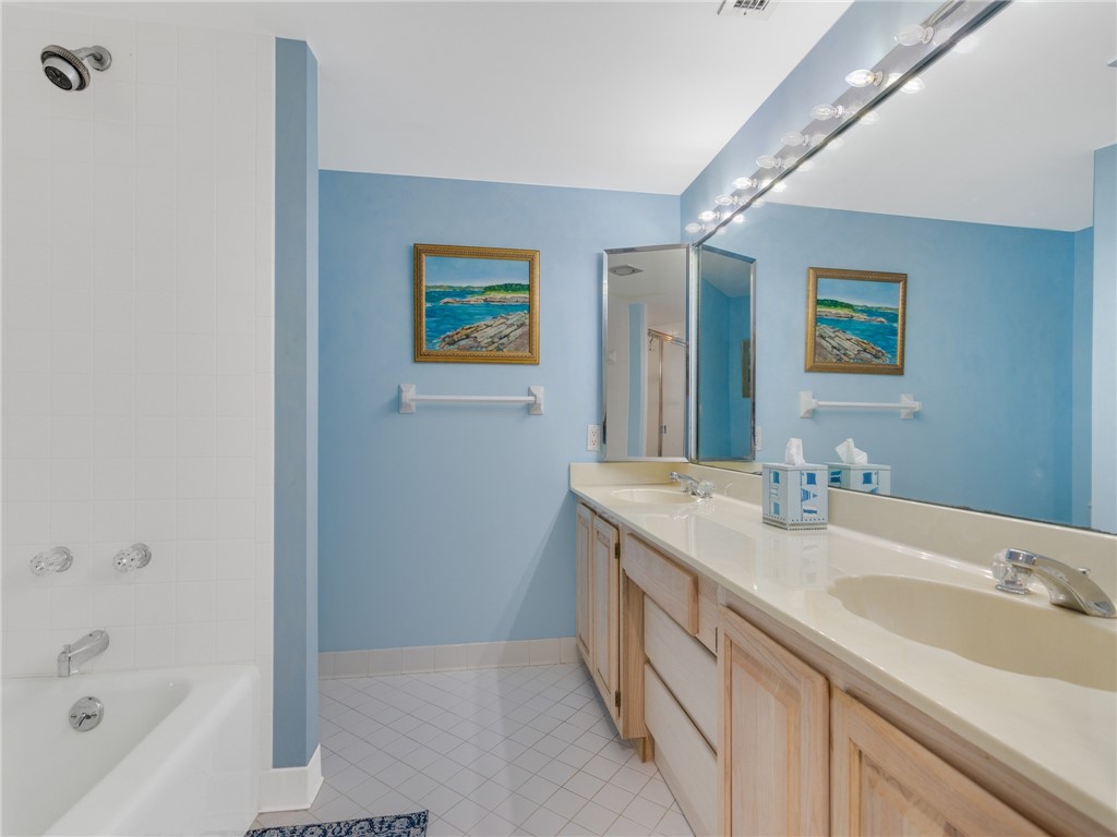 1880 Bay Road, Unit I319 Vero Beach, FL 32963 - Photo 22 of 36 a bathroom with a sink a mirror and a bathtub
