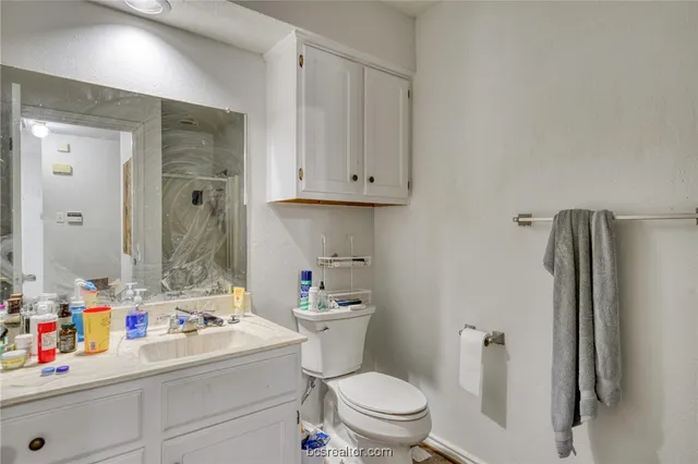 a bathroom with a sink toilet vanity and tub