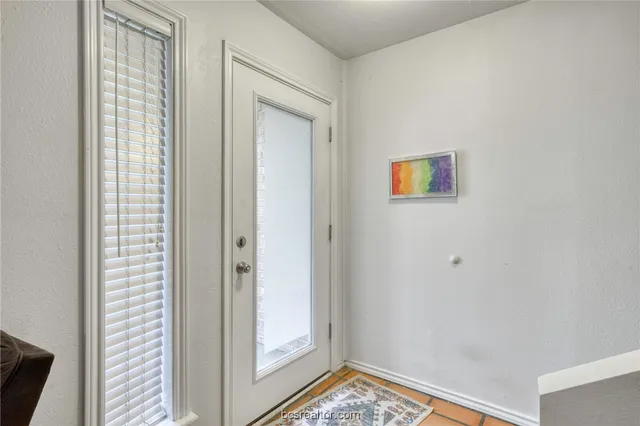 a view of a hallway with a small yard